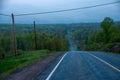 A blue morning on a country road with a big steep hill Royalty Free Stock Photo