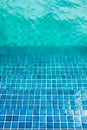 Blue mosaic tiled steps in green swimming pool Royalty Free Stock Photo