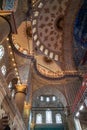 The blue mosque beautiful interior ornamental decoration of dome ceiling, arch windows and columns and lighting with historical