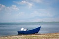 Blue motor boat on shore of wonderful Skadar lake on the background of mountains. Amazing giant Skadar Lake is a famous bird Royalty Free Stock Photo