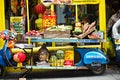 Blue motorbike display with fruits, vegetables, lampoons, buddha head in front of Chinese shop, Chinese Full Moon festival