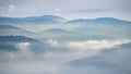 Blue mountains wrapped in clouds in northern Black Forest