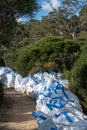 Blue Mountains, Australia - April 24 2019: Bags of track maintenance supplies and materials waiting for use beside a walking track