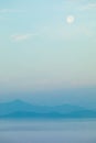 Blue mountains, fog an Moon in sky natural background Royalty Free Stock Photo