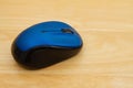 Blue mouse on a wood desk Royalty Free Stock Photo