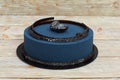 Blue mousse cake on white wooden background