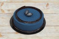 Blue mousse cake on wooden background