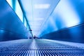 Blue moving escalator in the office hall Royalty Free Stock Photo