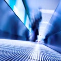 Blue moving escalator in the office hall Royalty Free Stock Photo