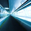 Blue moving escalator in the office hall Royalty Free Stock Photo