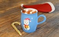 Blue mug with cocoa and marshmallows on a wooden table, 3d render. Christmas greeting card. Cup with hot chocolate, a cinnamon Royalty Free Stock Photo