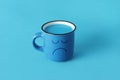 Blue mug with a sad face Royalty Free Stock Photo