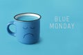 Blue mug with sad face and text blue monday