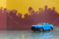 Blue muscle car toy selective focus on blur city background Royalty Free Stock Photo