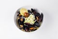 Blue mussels in a creamy sauce with lemon and olive in white bow