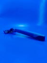 blue mustache shaving and beard trimming with used razor blade on blue background Royalty Free Stock Photo