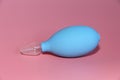 Blue nasal aspirator with glass tip. Suction of discharge from the baby spout