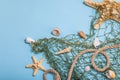 Blue nautical background with sea shells, starfishes and fishing net. Assorted marine animals Royalty Free Stock Photo