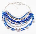 Blue necklace from natural gemstones on white
