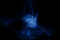 Blue neon intertwined smoke. Isolated on black background. Color of the year 2020 concept.