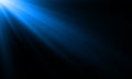 Blue neon light ray sun beam vector background. Abstract neon light flash spotlight backdrop with sunlight shine on black Royalty Free Stock Photo