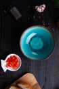 Blue nice bowl and ingredients served at dark wooden table. meditarranean cuisine. flat lay