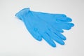 Blue nitrile medical gloves on white table.