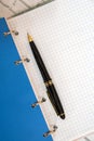 Blue notebook with black ballpoint pen Royalty Free Stock Photo