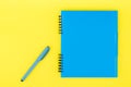 A blue notebook with a handle on a yellow background. Flat Lay Template. Place for text. Royalty Free Stock Photo