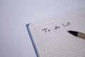 Blue notebook with a pen on it and a sign `To do list` on it - handwritten. stationery concept. copy space. isolated Royalty Free Stock Photo