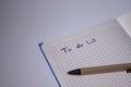 Blue notebook with a pen on it and a sign `To do list` on it - handwritten. stationery concept. copy space. isolated Royalty Free Stock Photo