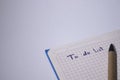 Blue notebook with a pen on it and a sign `To do list` on it - handwritten. stationery concept. copy space. isolated Royalty Free Stock Photo