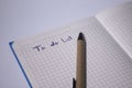 Blue notebook with a pen on it and a sign `To do list` on it - handwritten. stationery concept. copy space. isolated Royalty Free Stock Photo