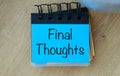 A blue notebook with a yellow and green strip on it that says Final Thoughts. Royalty Free Stock Photo