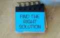 A blue notebook with a yellow and green strip on it that says Find the Right Solution. Royalty Free Stock Photo