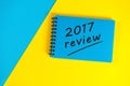 Blue notepad with review 2017. New year 2018 - Time to summarize and plan goals for the next year. Business background