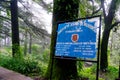 Blue notice board giving the history and information about the St John in wilderness church in McLeodganj
