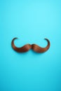Blue november concept. Mustache isolated on a blue background