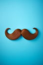 Blue november concept. Mustache isolated on a blue background