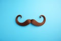 Blue november concept. Mustache isolated on a blue background