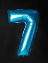 Blue number seven balloon on black