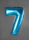 Blue number seven balloon on background