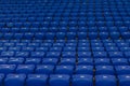 Blue numbered seats on the stands of the stadium in daylight