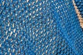 Blue nylon fishing net. Nautical equipment. Marine background