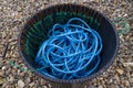 Blue Nylon Rope, black bin, pebbled beach Royalty Free Stock Photo
