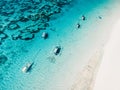 Blue ocean and beach with fishing boats in tropics. Aerial view Royalty Free Stock Photo