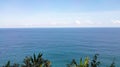 Blue Ocean Horizon under Clear Sky with Tropical Foliage Foreground Royalty Free Stock Photo