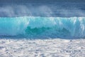 Blue ocean shorebreak wave front view