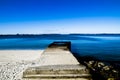 Boat ramp or launch is also known as slipway on the shore with Dark blue sea and sky. Royalty Free Stock Photo
