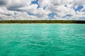 Blue ocean before stone sand beach